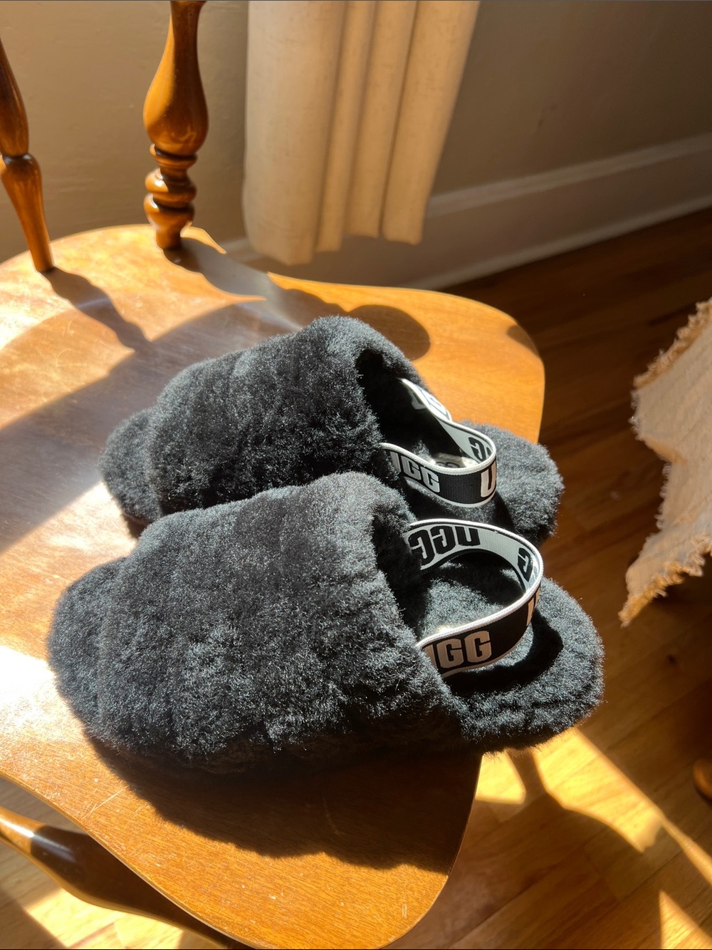 UGG women’s Black Fuzz Slip-On with Branded Heel Strap